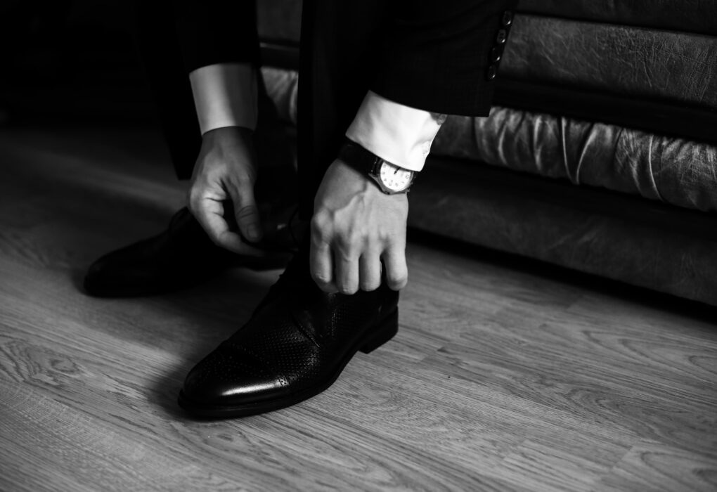mężczyzna wiąże buty do garnituru
