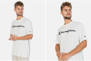 Mężczyzna w białej koszulce marki Champion, z czarnym napisem "Champion" na klatce piersiowej stoi na białym tle.